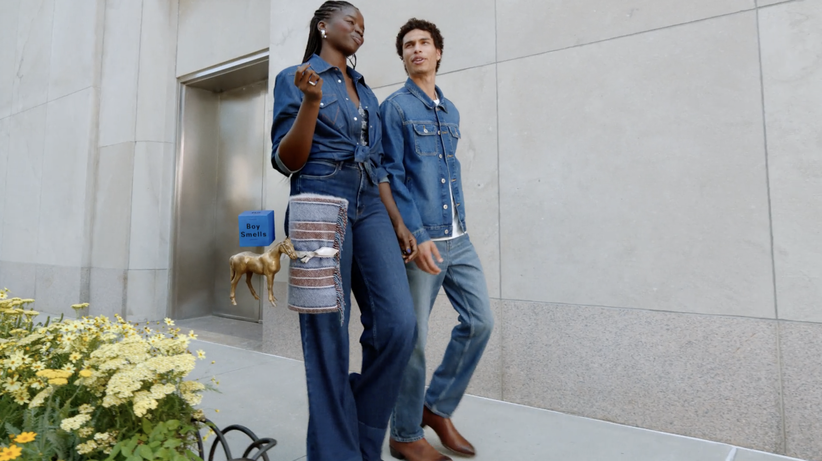 Two models walking in denim